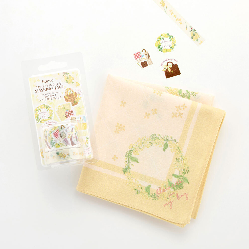 白い背景の上に、菜の花のイラストがあしらわれた黄色いハンカチと、同じ菜の花のイラストが使われたbandeが並んでいる画像